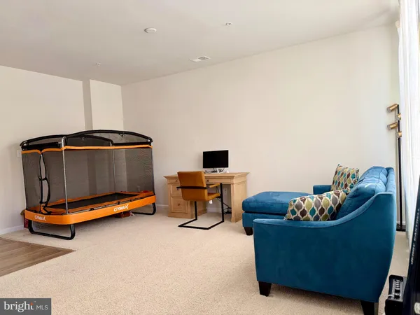 a living room with furniture gym equipment and a view of living room