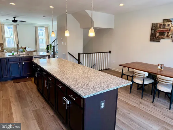 a kitchen with kitchen island a sink table and chairs
