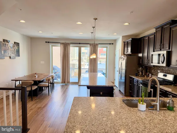 a living room with hard wood flooring and furniture