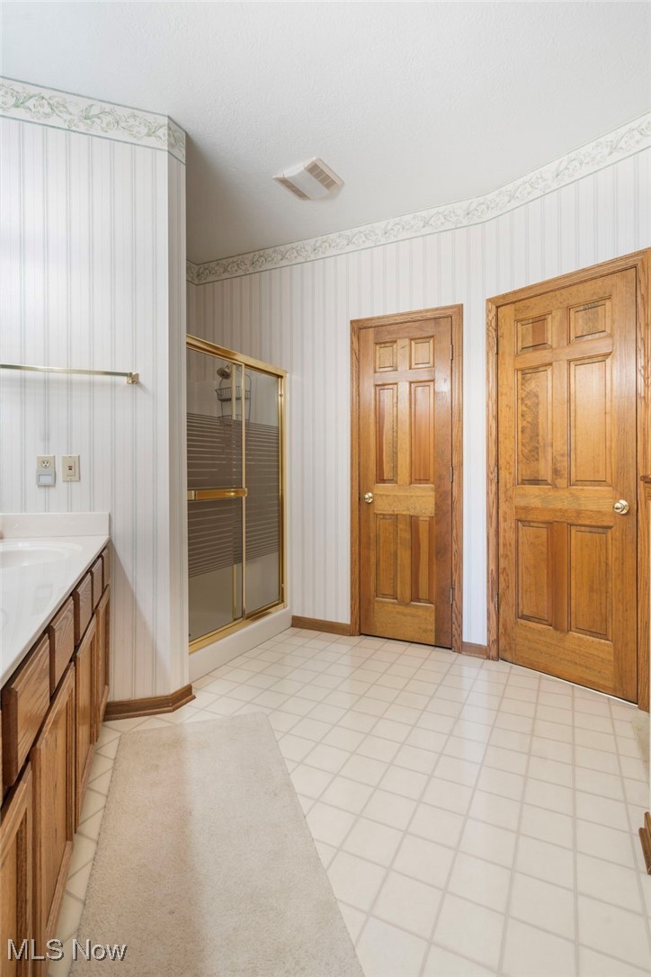 2503 Charing Cross Road Northwest Canton, OH 44708 - Photo 18 of 30 Bathroom with vanity, walk in shower, and tile patterned floors