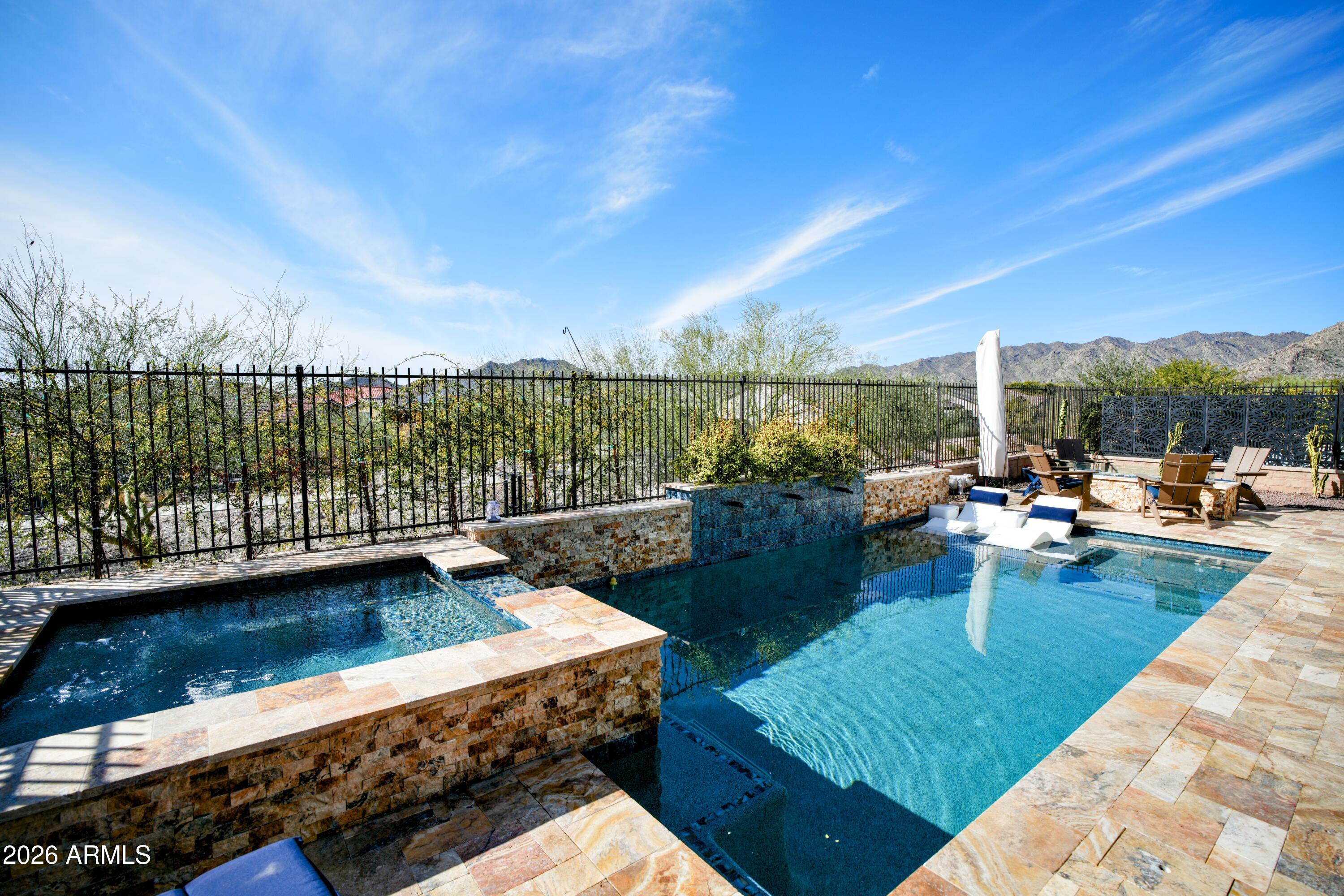 20471 West Coolidge Street Buckeye, AZ 85396 - Photo 18 of 41 a view of a swimming pool and lounge chairs in patio