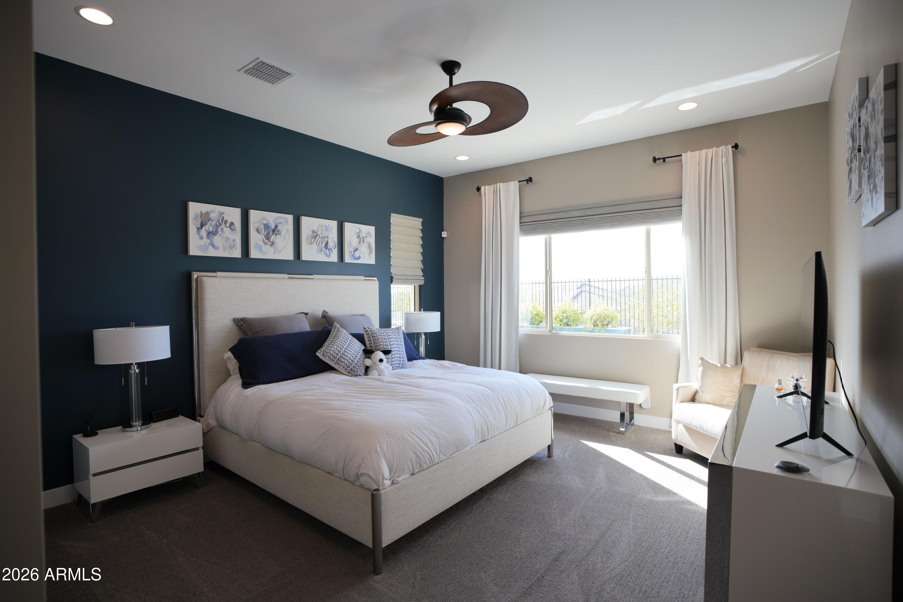 20471 West Coolidge Street Buckeye, AZ 85396 - Photo 27 of 41 a bedroom with a bed and a chandelier