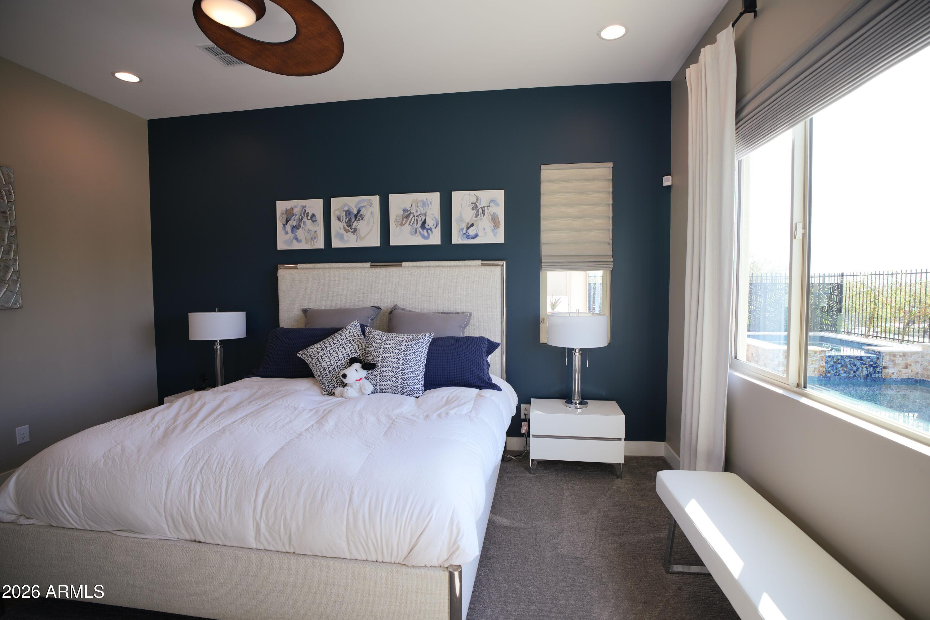 20471 West Coolidge Street Buckeye, AZ 85396 - Photo 28 of 41 a bedroom with a large bed and a window