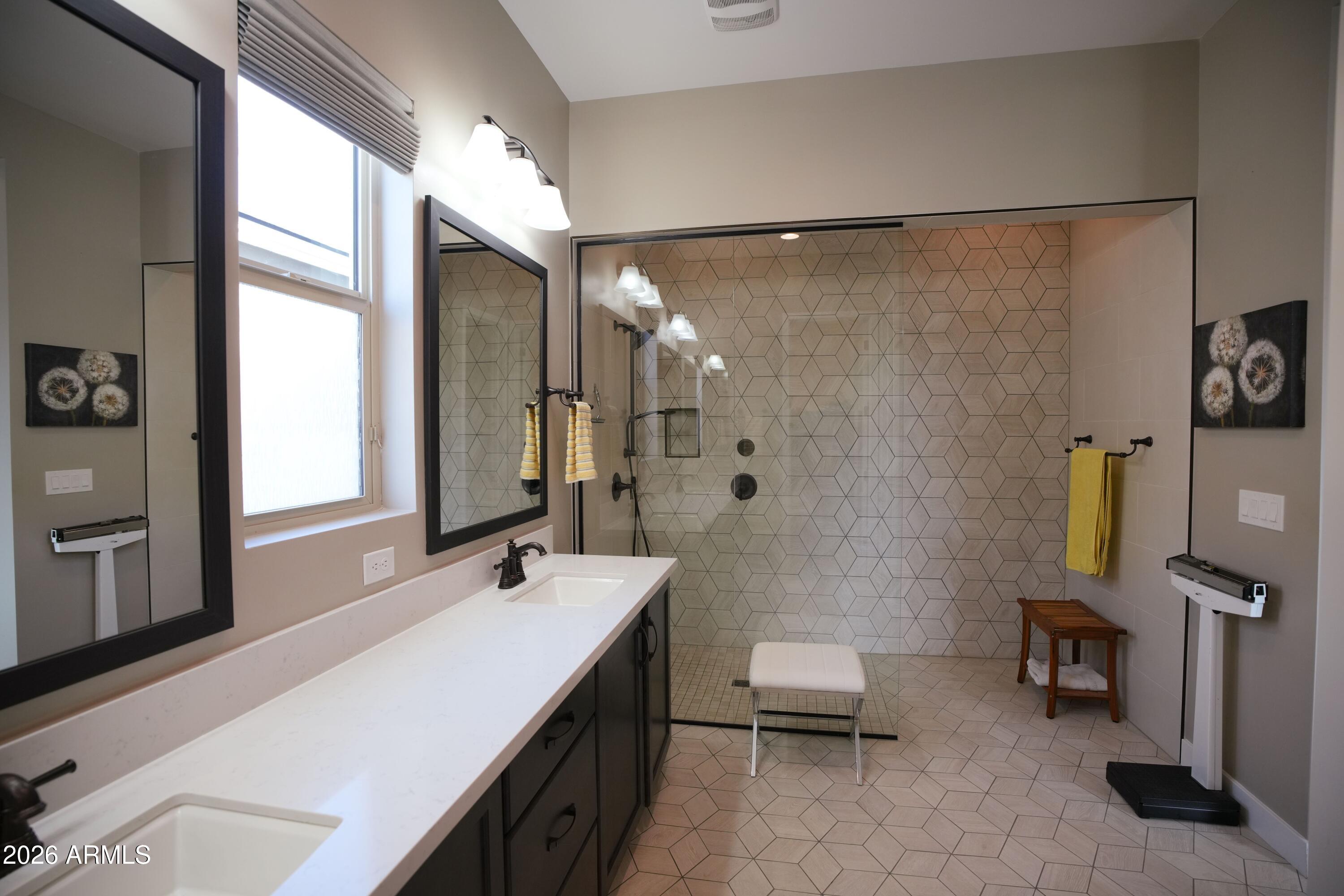 20471 West Coolidge Street Buckeye, AZ 85396 - Photo 30 of 41 a bathroom with a double vanity sink and a mirror