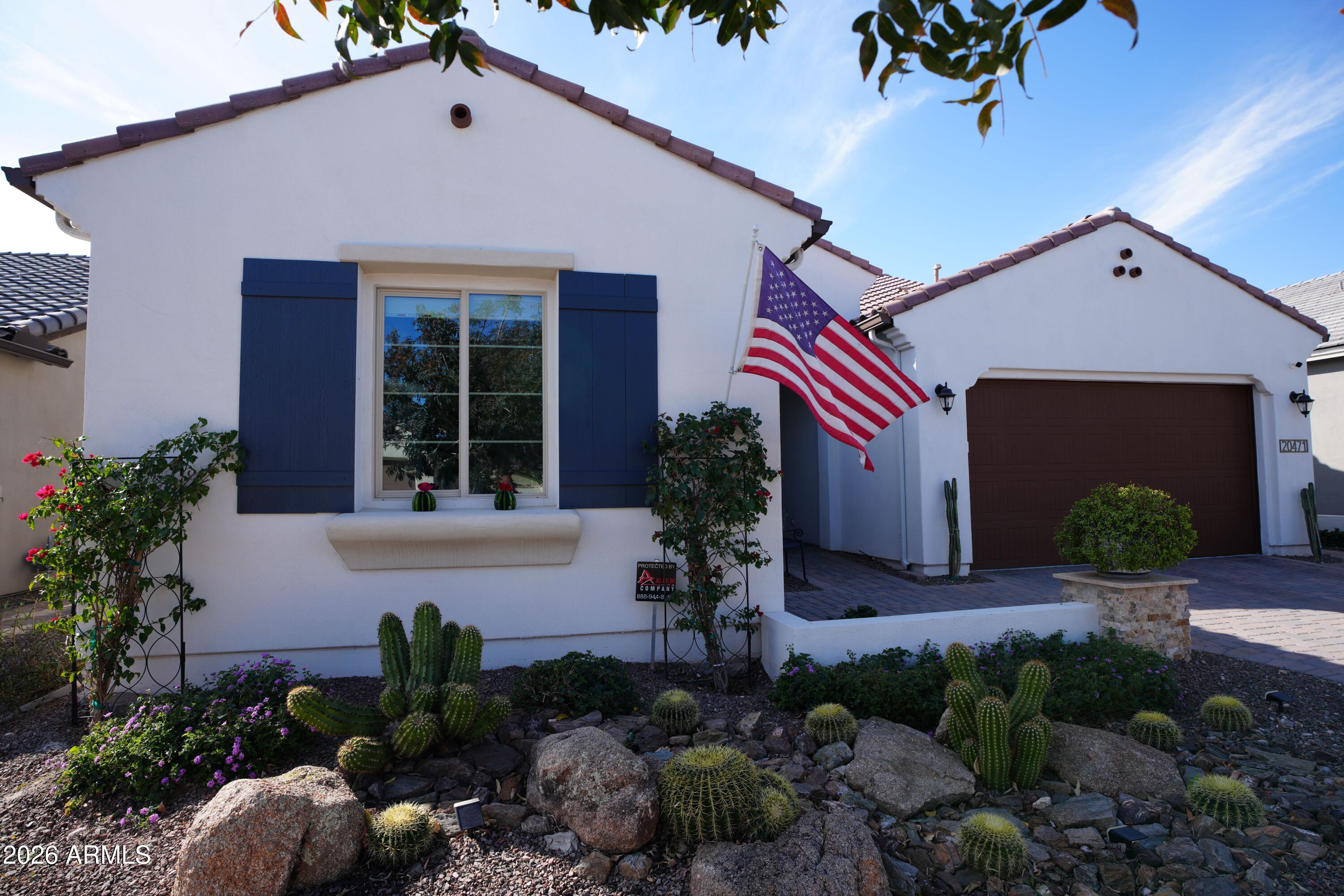20471 West Coolidge Street Buckeye, AZ 85396 - Photo 3 of 41 a front view of a house with garden