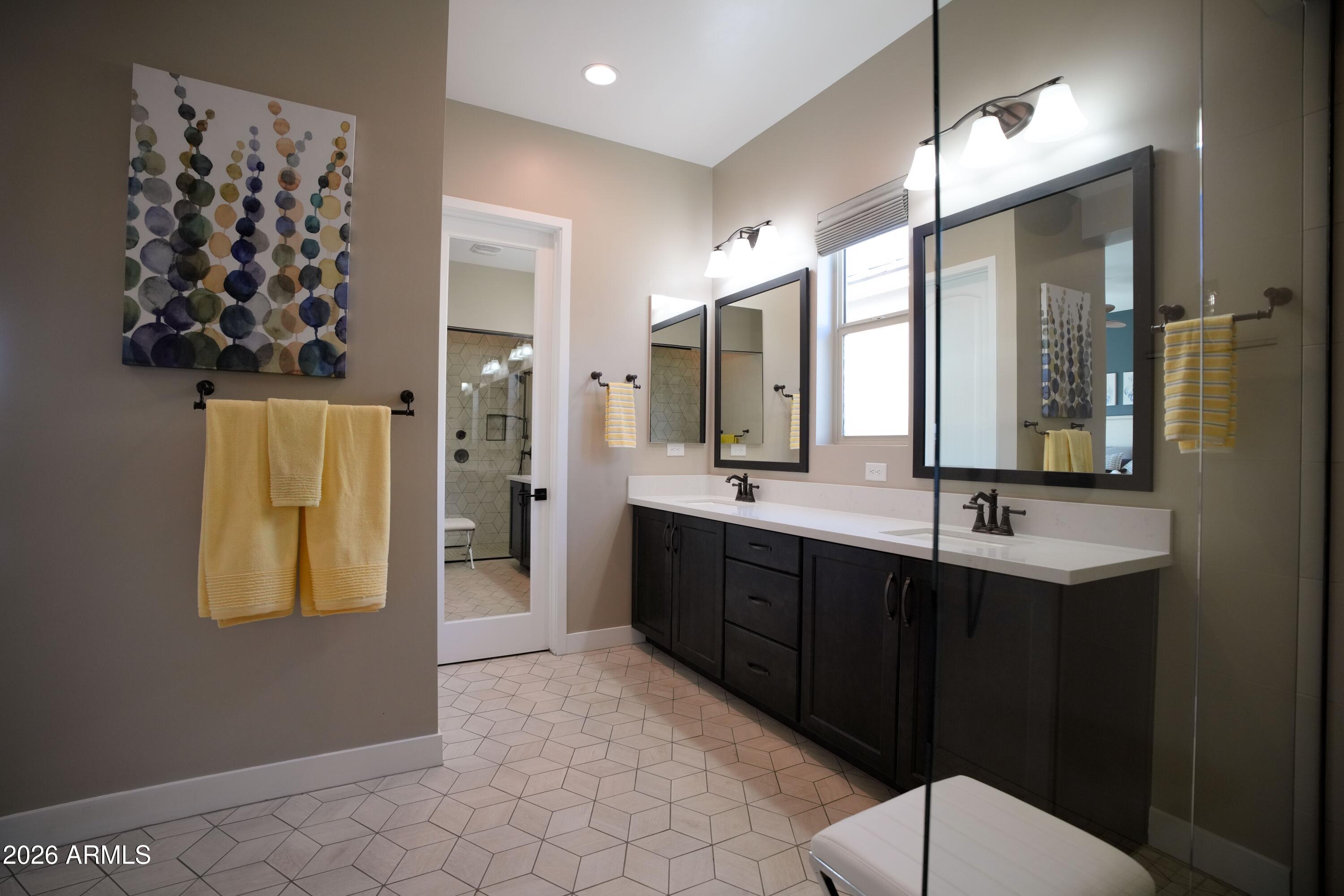 20471 West Coolidge Street Buckeye, AZ 85396 - Photo 32 of 41 a bathroom with a double vanity sink mirror and shower