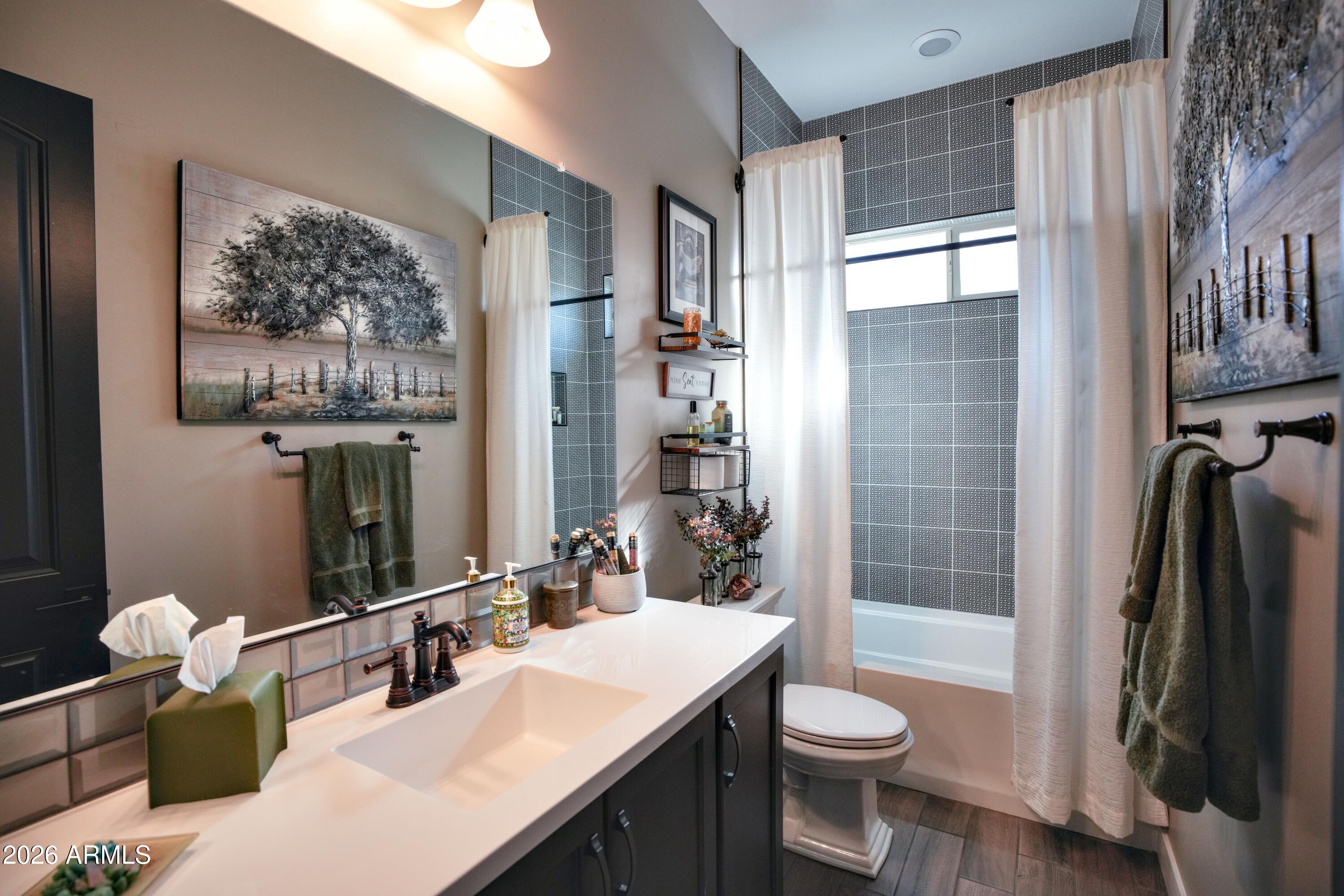 20471 West Coolidge Street Buckeye, AZ 85396 - Photo 38 of 41 a bathroom with a toilet a sink and mirror