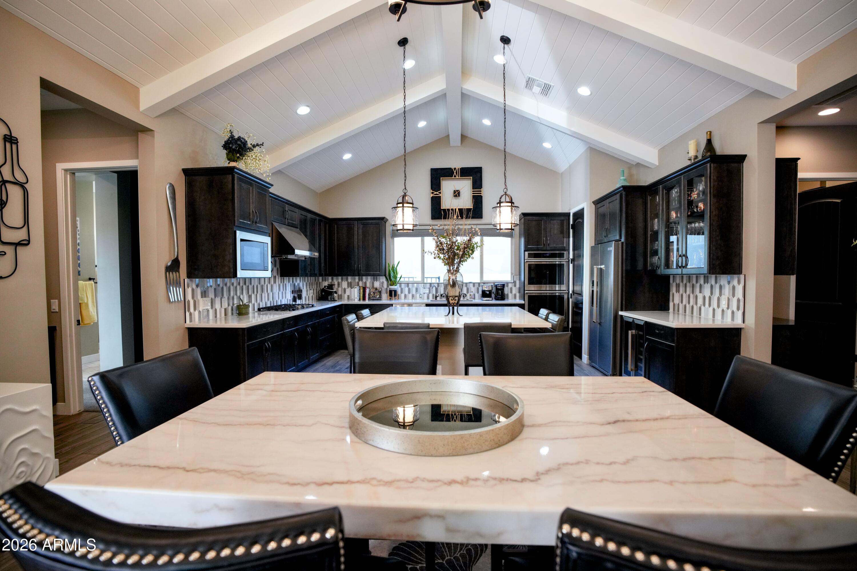 20471 West Coolidge Street Buckeye, AZ 85396 - Photo 7 of 41 a kitchen with a dining table and chairs