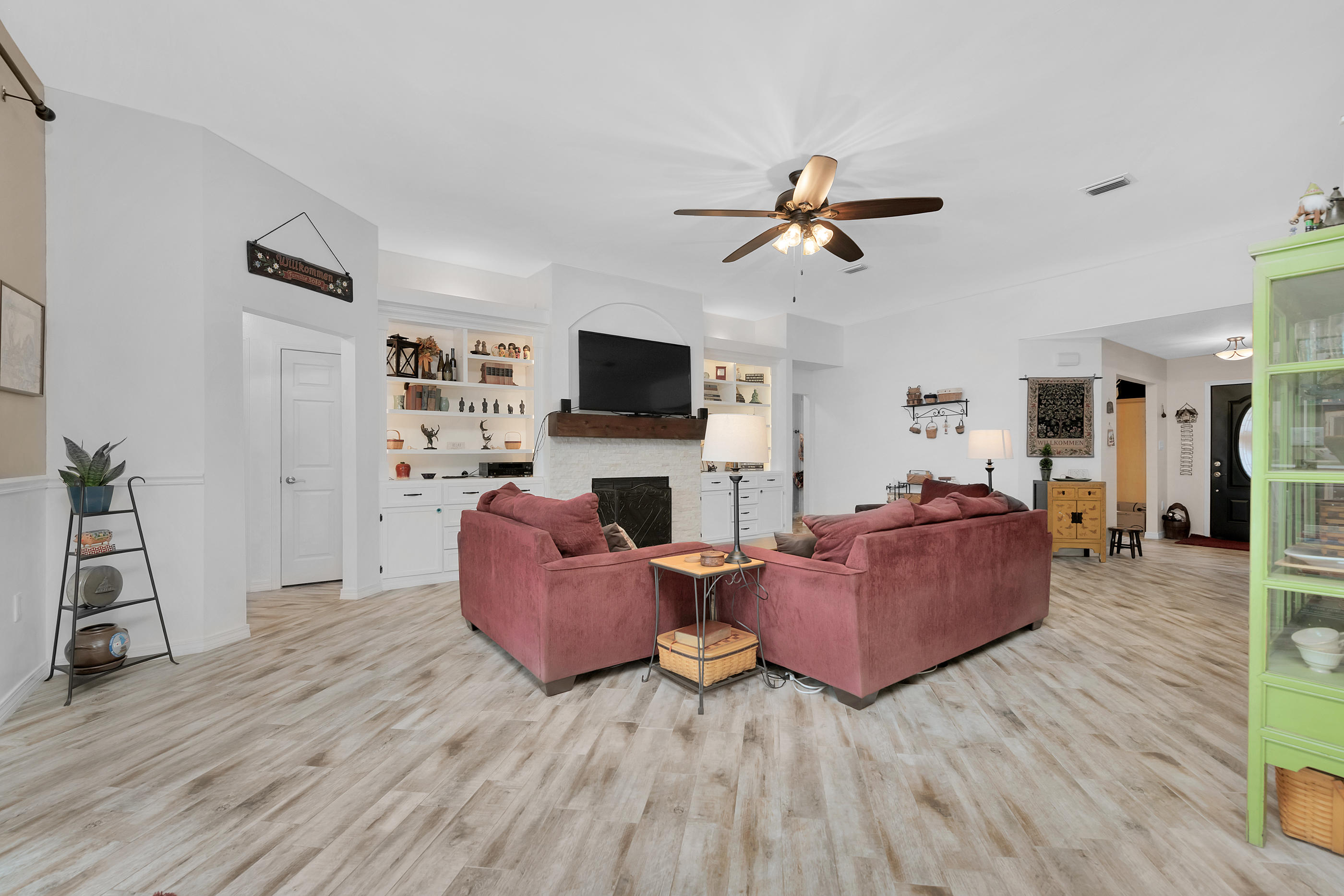 7159 Riverview Road Navarre, FL 32566 - Photo 12 of 36 a living room with furniture fireplace and flat screen tv