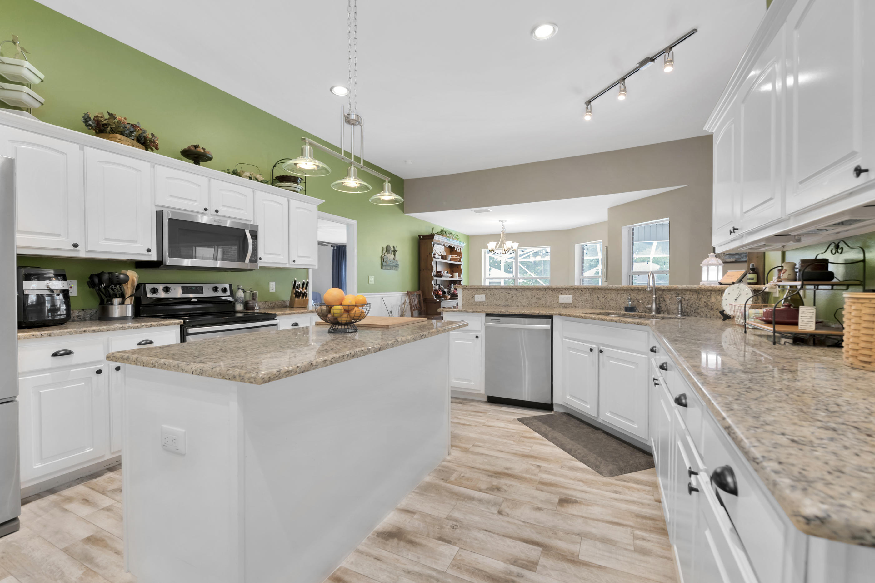 7159 Riverview Road Navarre, FL 32566 - Photo 15 of 36 a large kitchen with stainless steel appliances lots of counter space and a sink