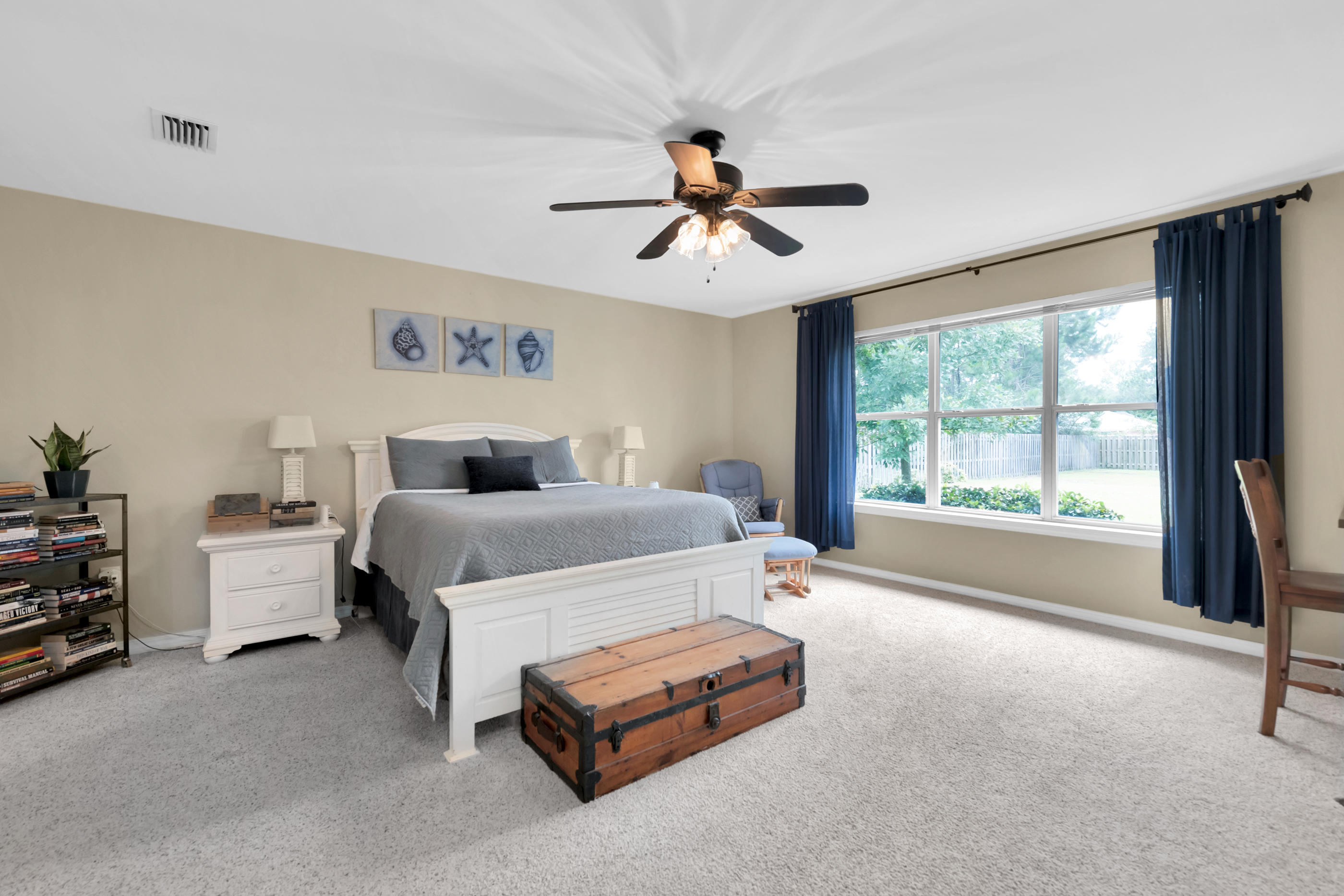 7159 Riverview Road Navarre, FL 32566 - Photo 17 of 36 a bedroom with a bed couch and window