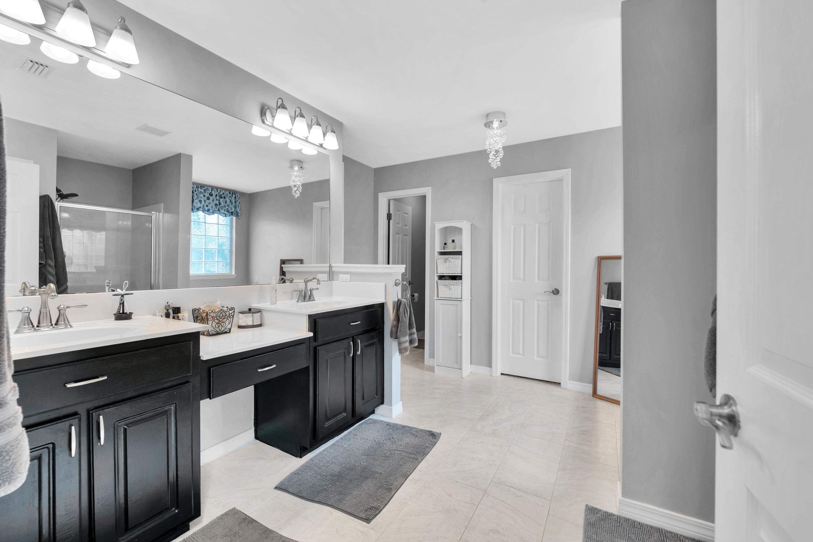7159 Riverview Road Navarre, FL 32566 - Photo 18 of 36 a large bathroom with a double vanity sink mirror and double