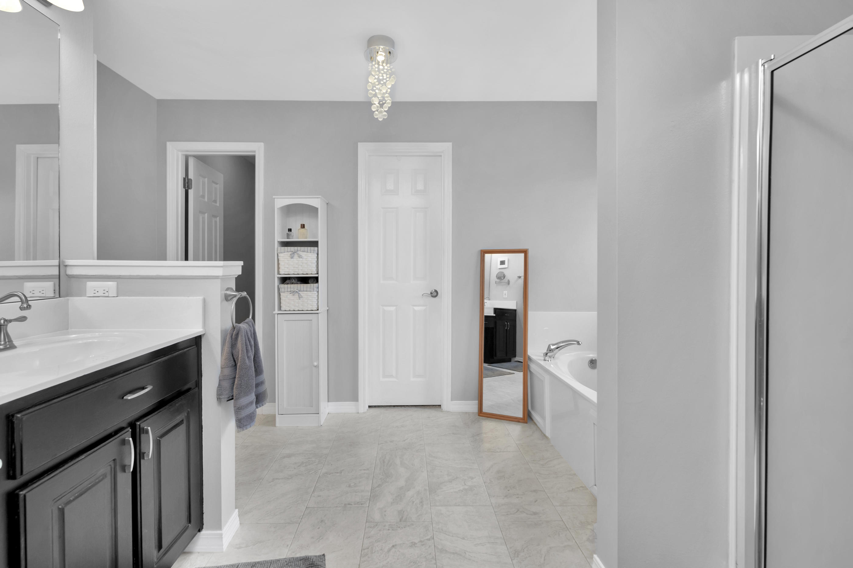 7159 Riverview Road Navarre, FL 32566 - Photo 19 of 36 a spacious bathroom with a granite countertop sink a mirror and a bathtub