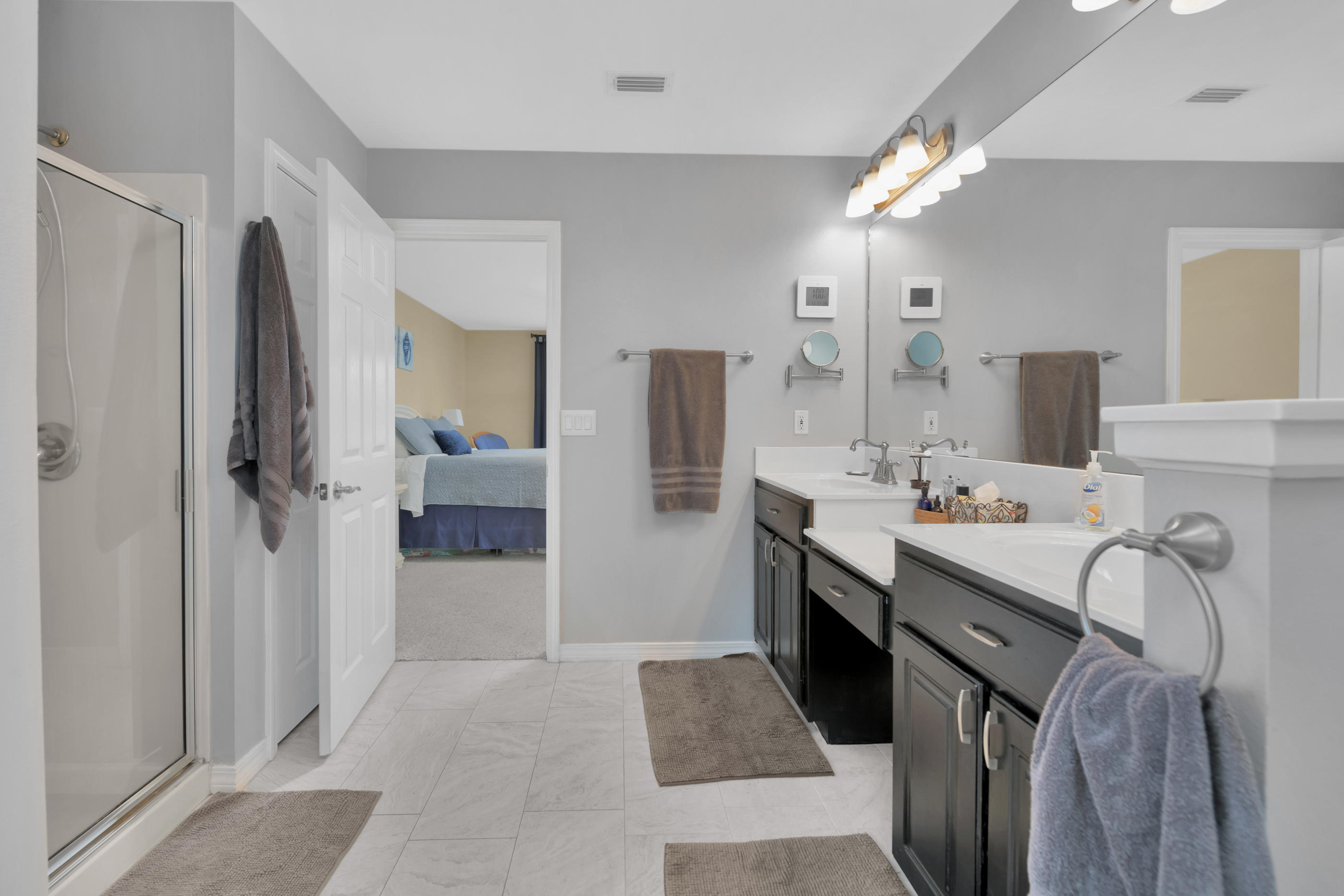7159 Riverview Road Navarre, FL 32566 - Photo 20 of 36 a bathroom with a double vanity sink mirror and shower