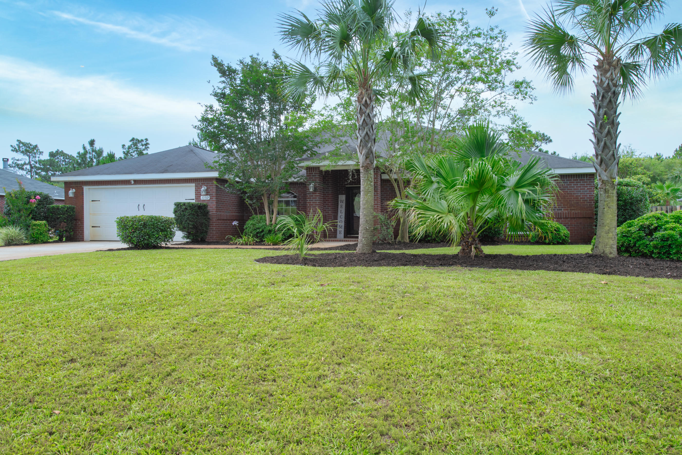 7159 Riverview Road Navarre, FL 32566 - Photo 2 of 36 a front view of house with yard and green space