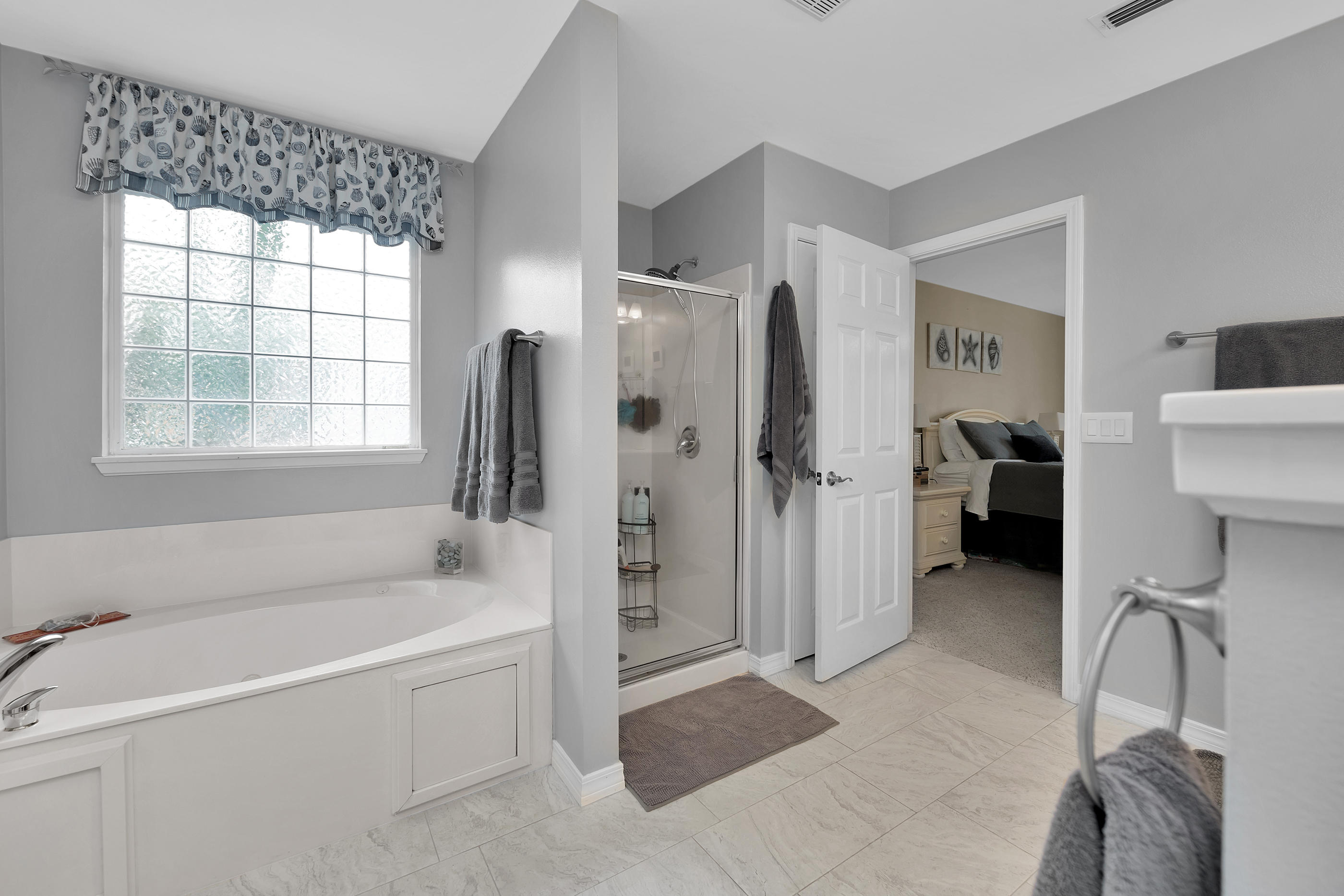 7159 Riverview Road Navarre, FL 32566 - Photo 21 of 36 a bathroom with a bathtub and a shower