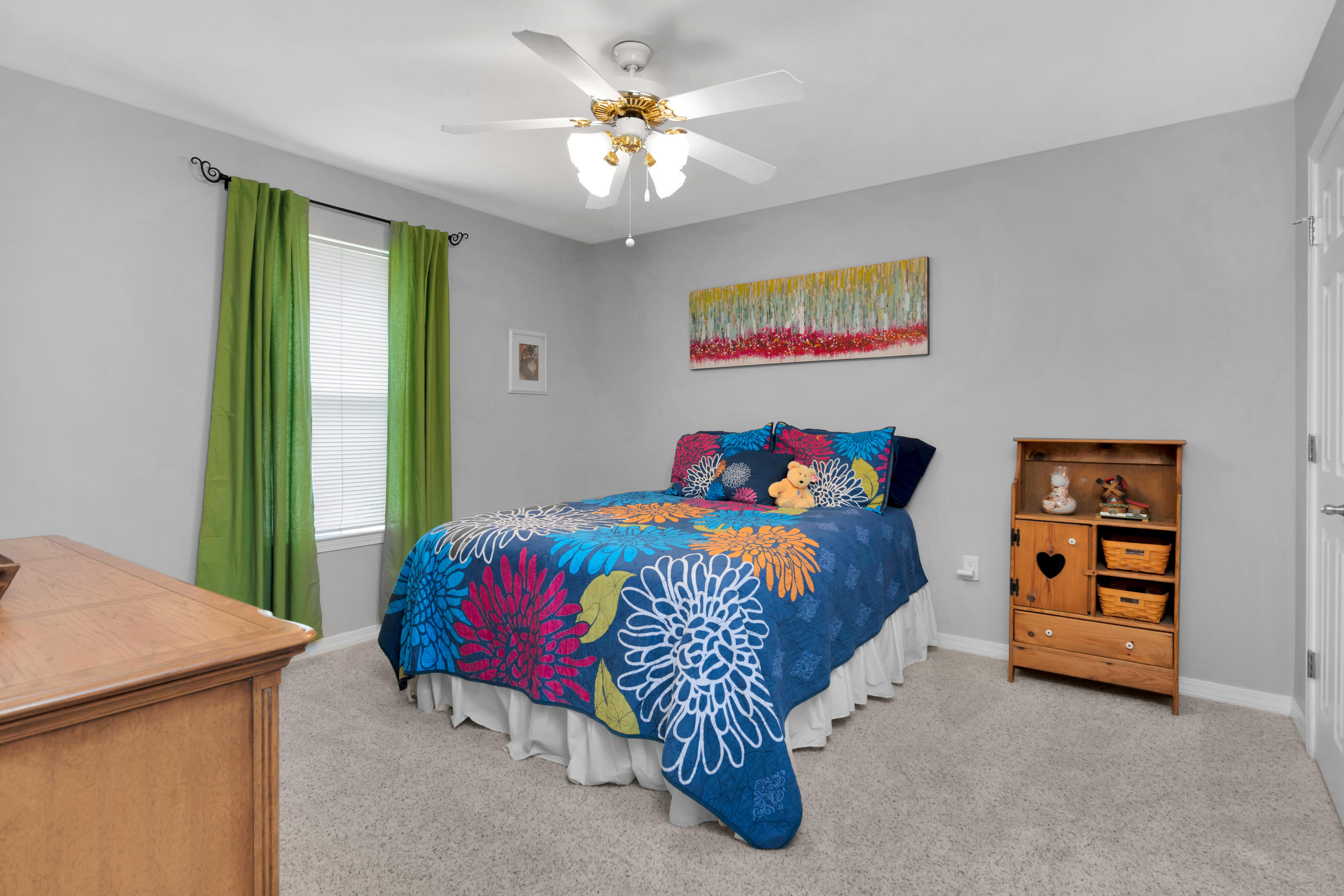 7159 Riverview Road Navarre, FL 32566 - Photo 22 of 36 a bedroom with a bed and a chandelier