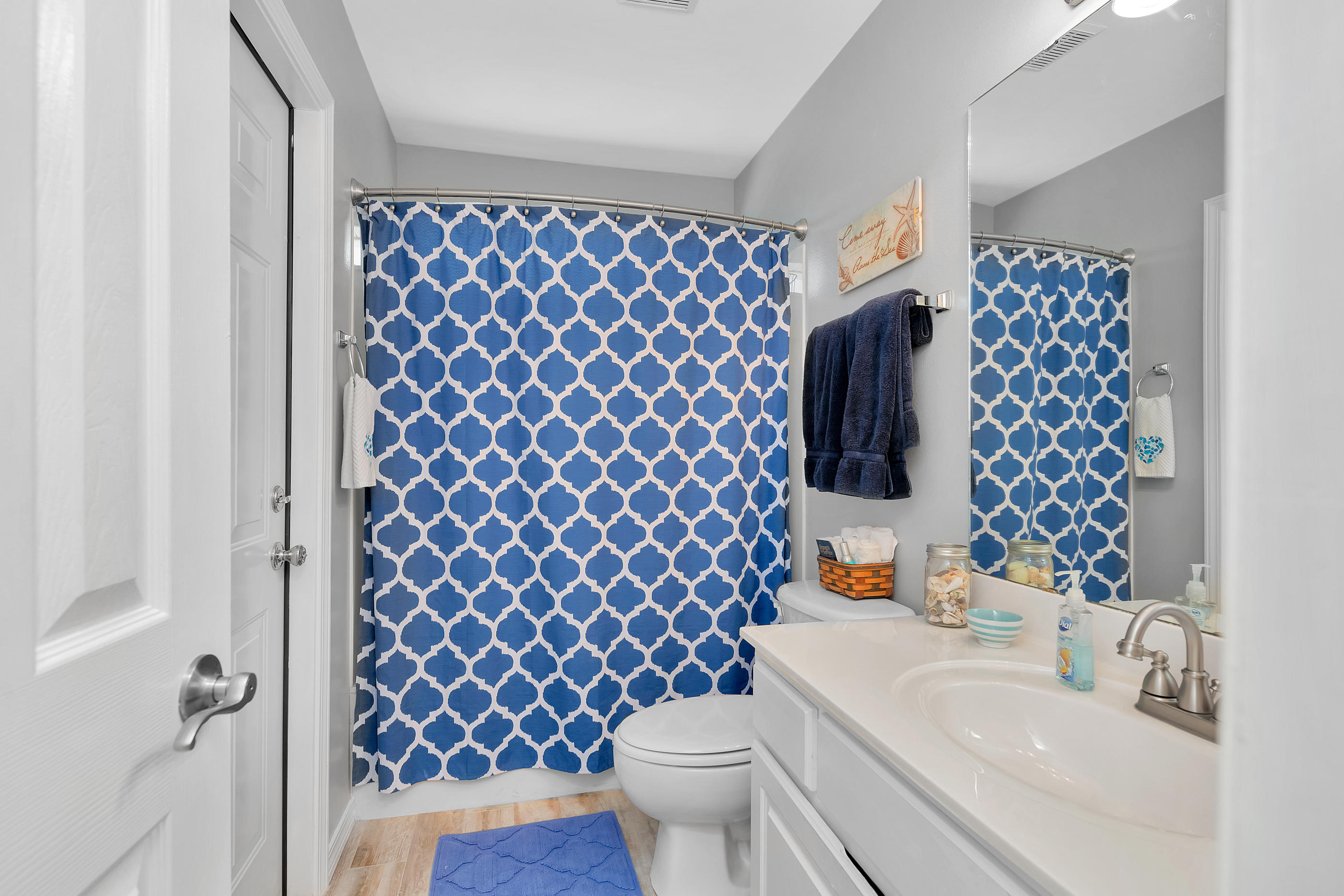 7159 Riverview Road Navarre, FL 32566 - Photo 23 of 36 a bathroom with a sink toilet and a mirror