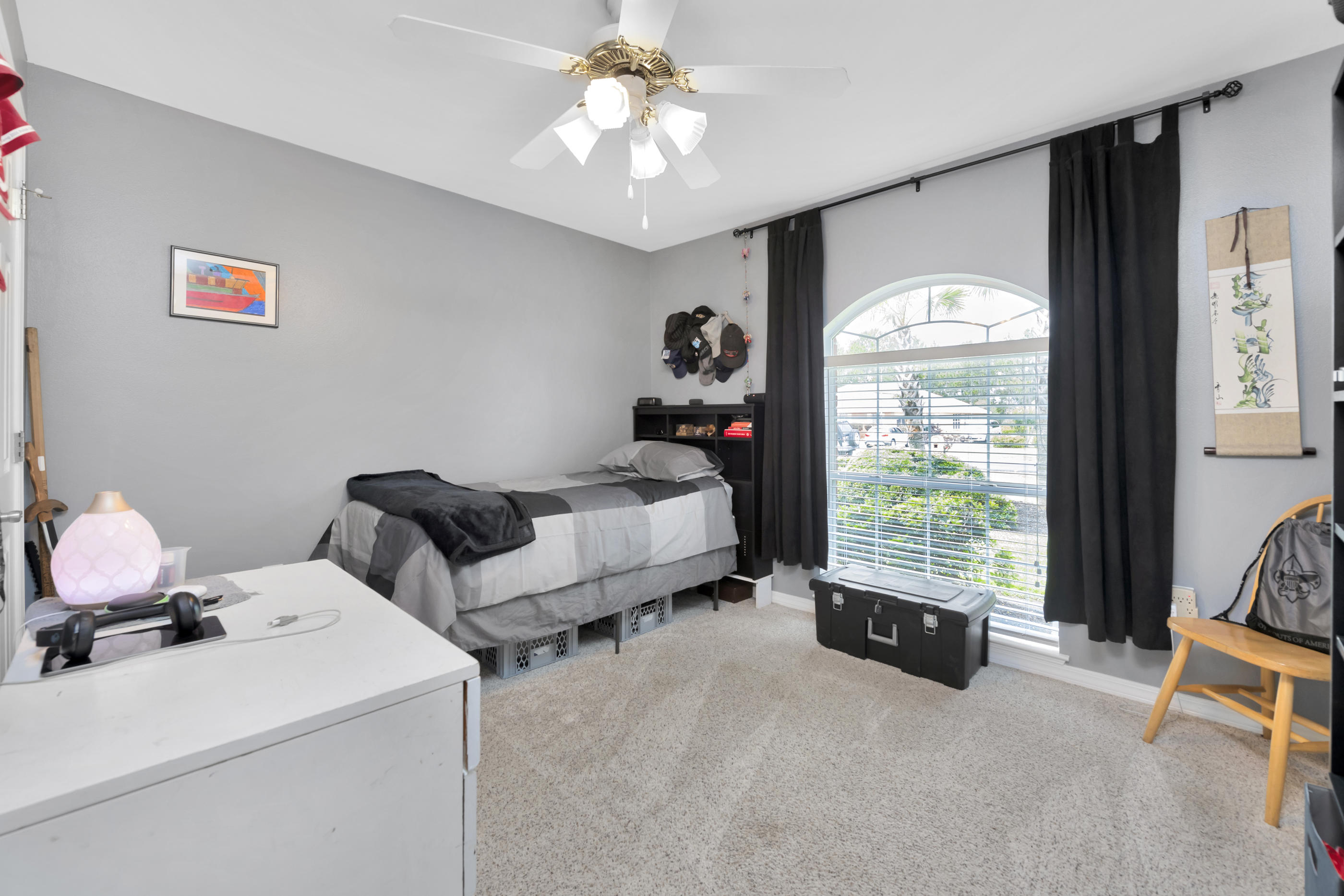 7159 Riverview Road Navarre, FL 32566 - Photo 25 of 36 a bed room with a bed and a tv