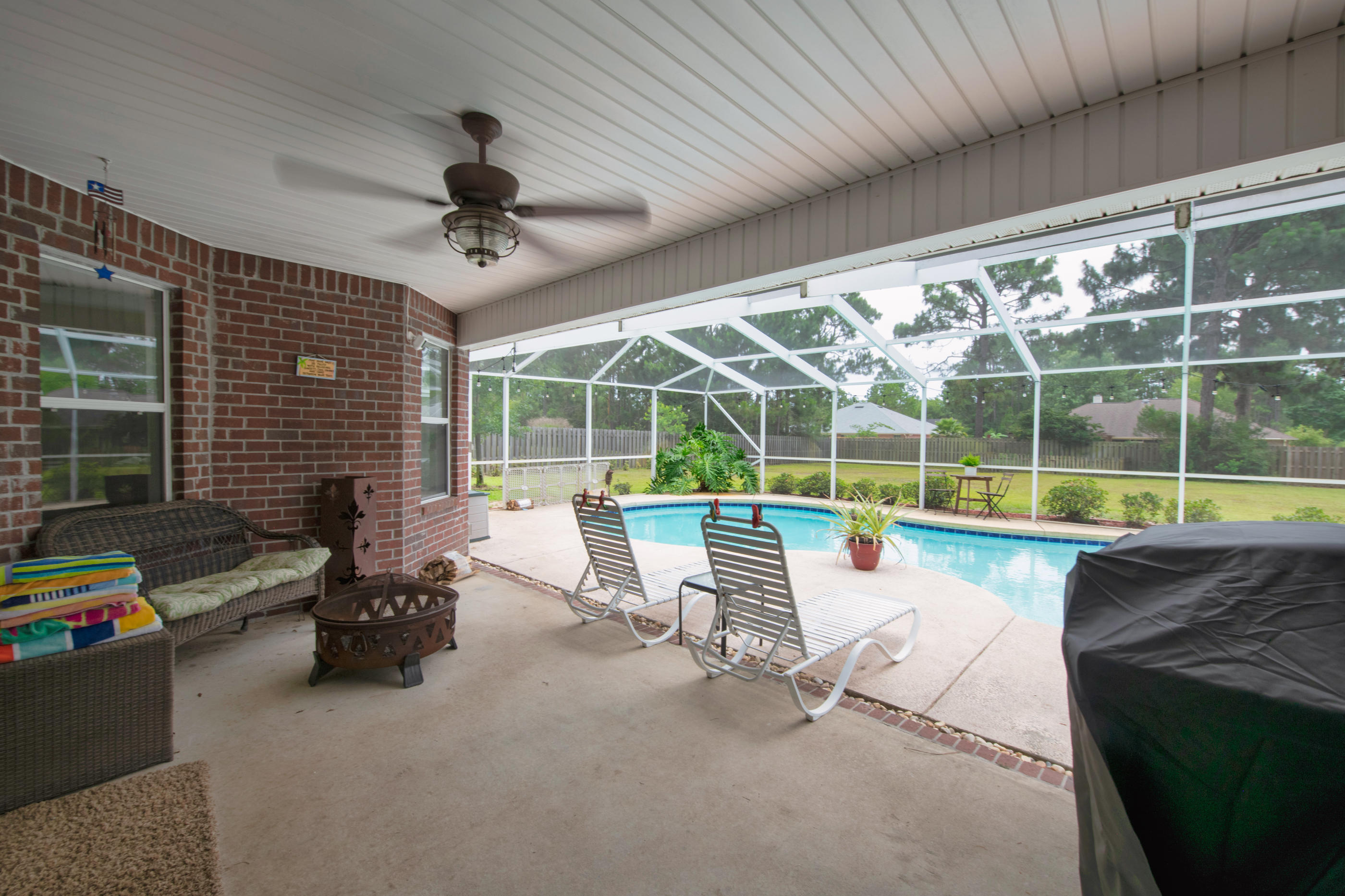 7159 Riverview Road Navarre, FL 32566 - Photo 28 of 36 a view of a roof deck with a table and chairs