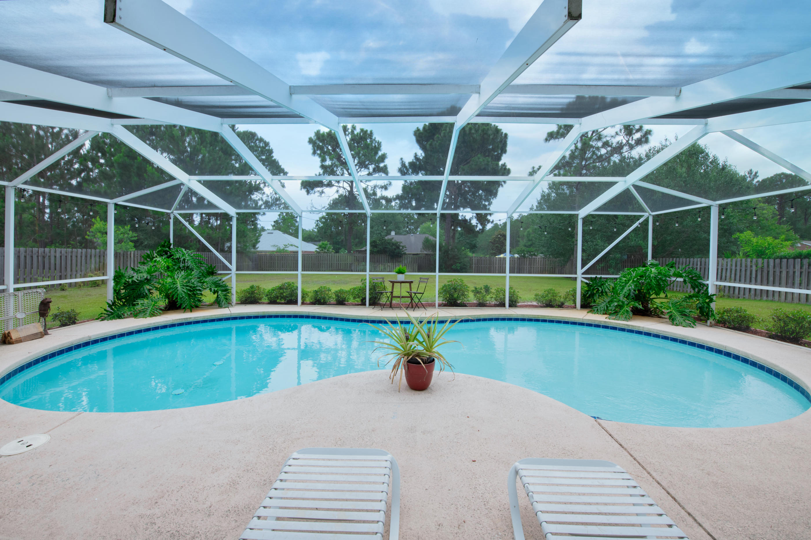 7159 Riverview Road Navarre, FL 32566 - Photo 29 of 36 a view of a backyard with swimming pool