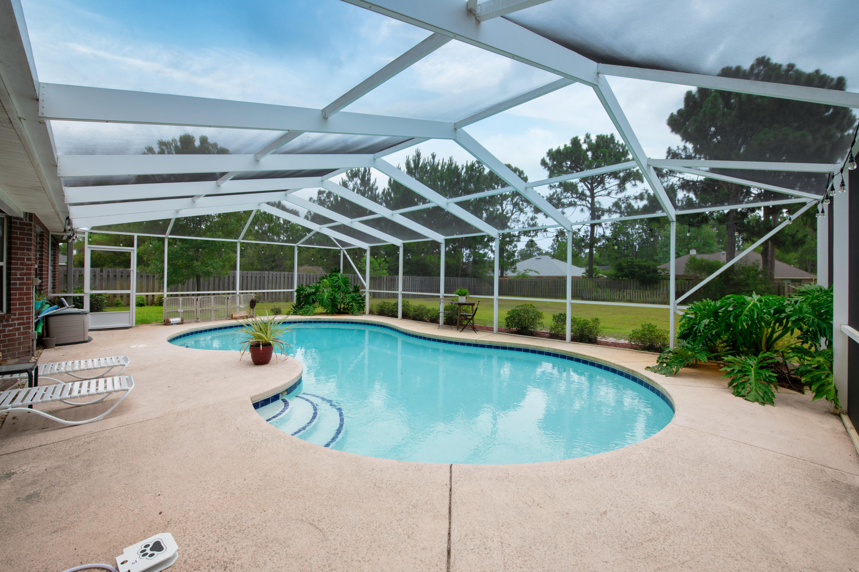 7159 Riverview Road Navarre, FL 32566 - Photo 30 of 36 a view of a swimming pool with a patio
