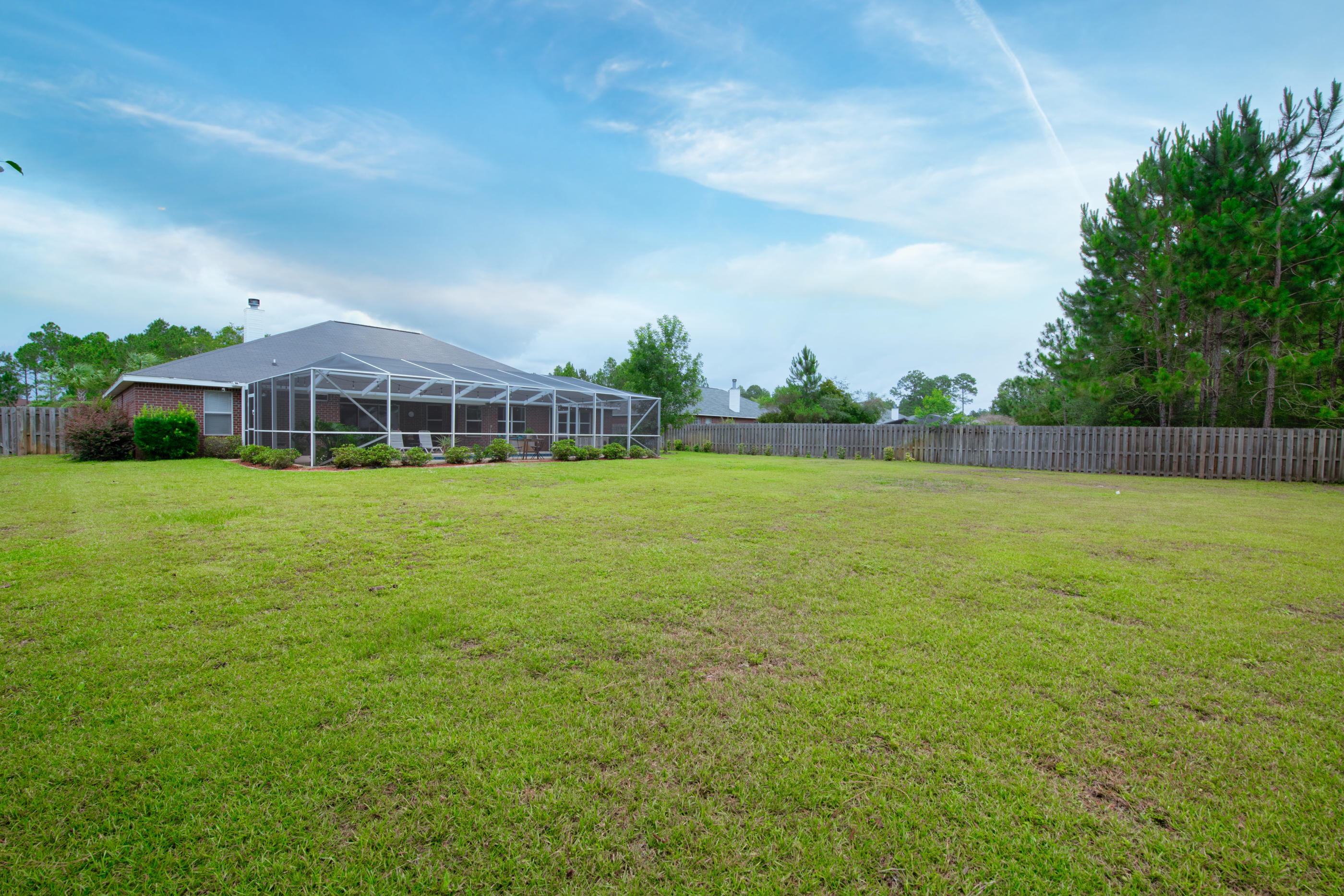 7159 Riverview Road Navarre, FL 32566 - Photo 34 of 36 a view of a house with a yard