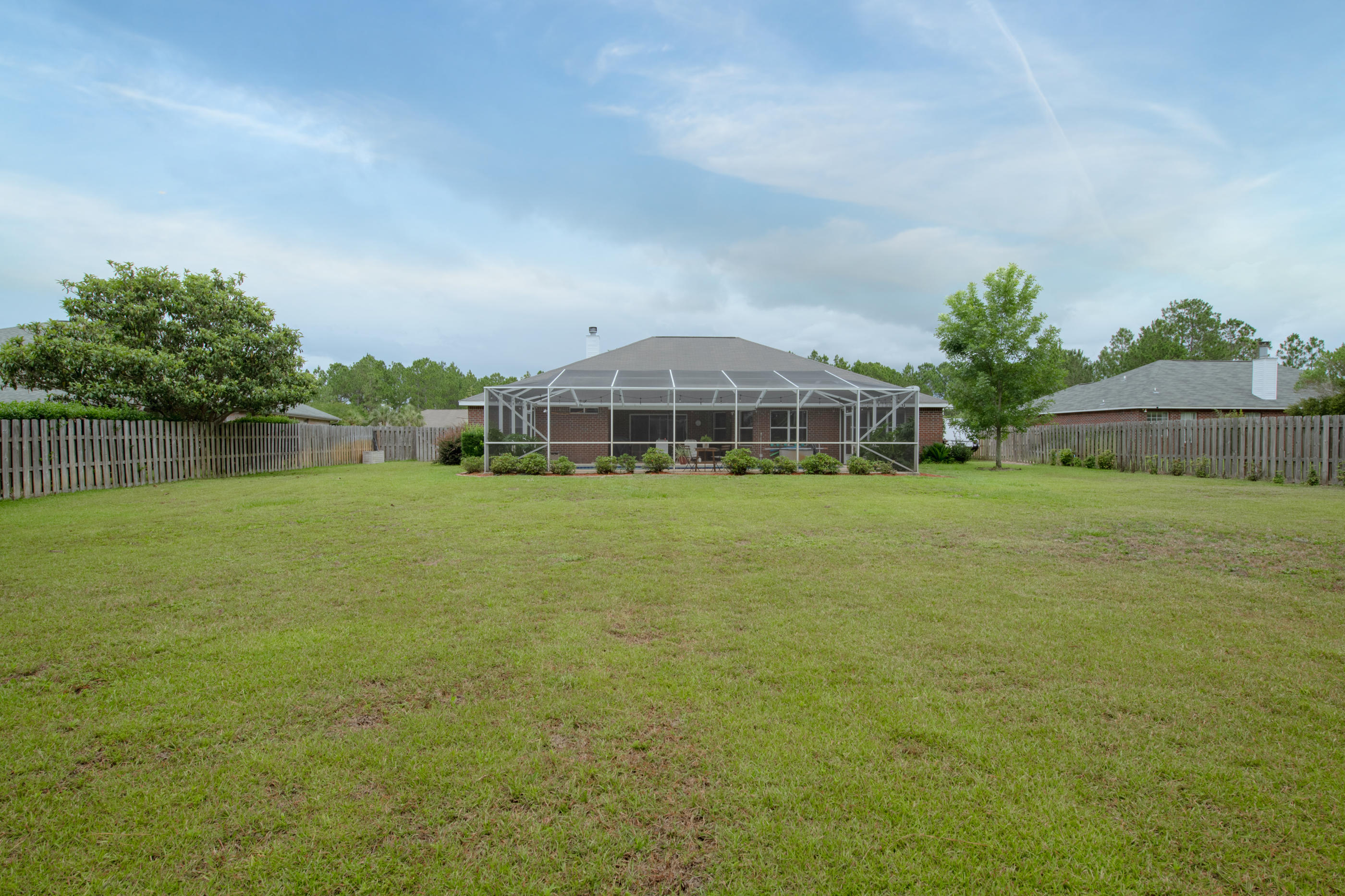 7159 Riverview Road Navarre, FL 32566 - Photo 35 of 36 a view of a lake with a big yard and large trees