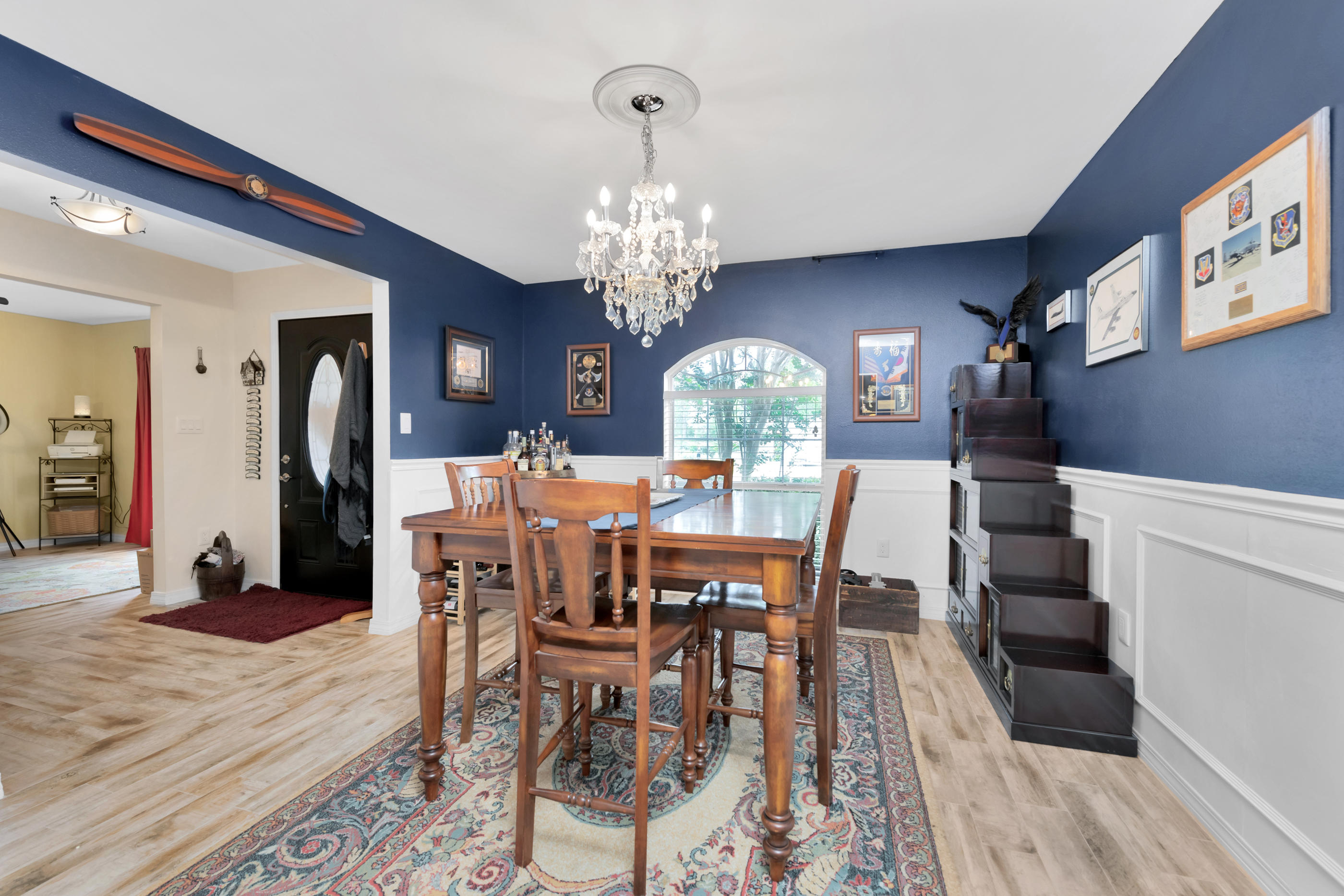 7159 Riverview Road Navarre, FL 32566 - Photo 7 of 36 a view of a dining room with furniture and wooden floor