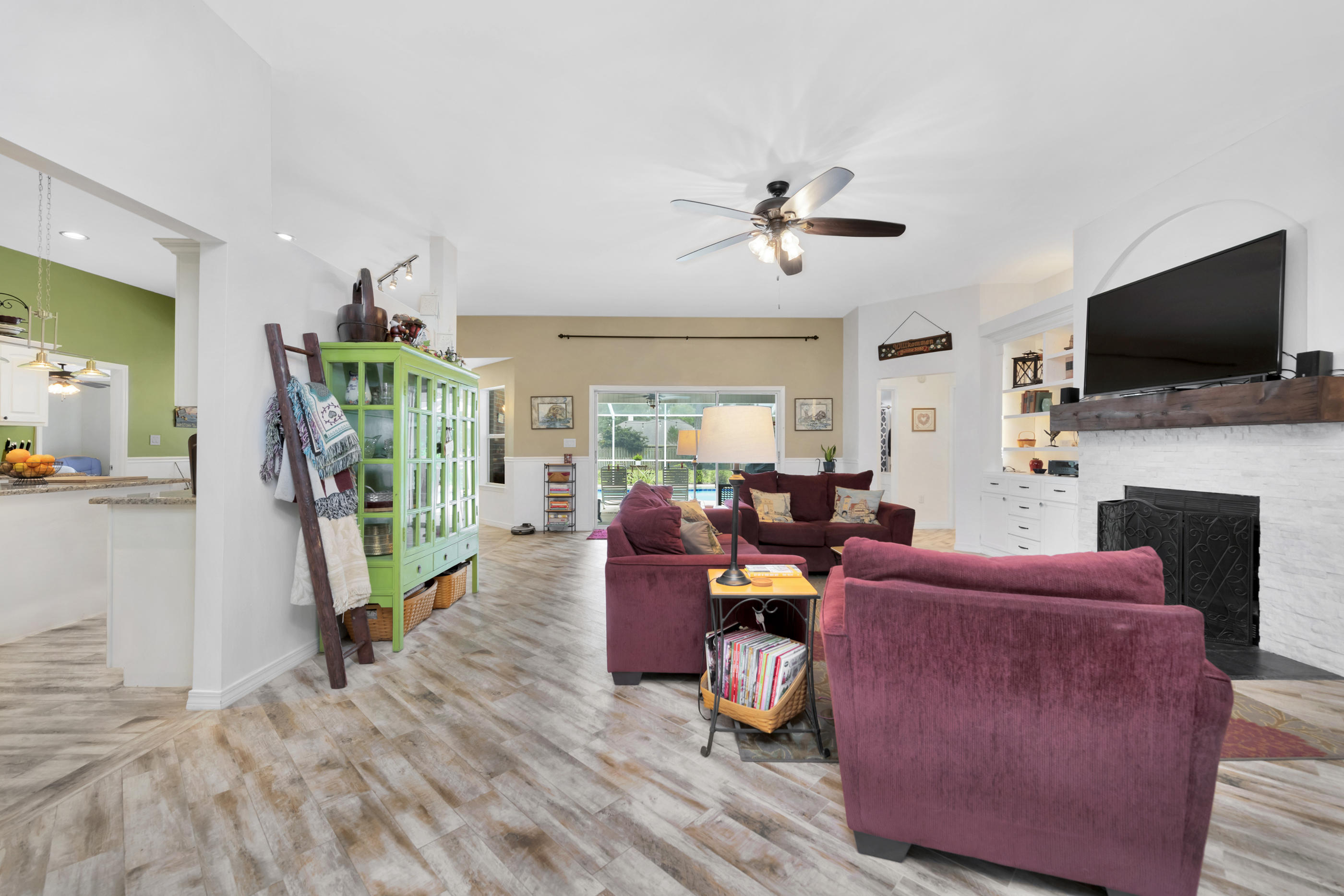 7159 Riverview Road Navarre, FL 32566 - Photo 8 of 36 a living room with fireplace furniture and a flat screen tv