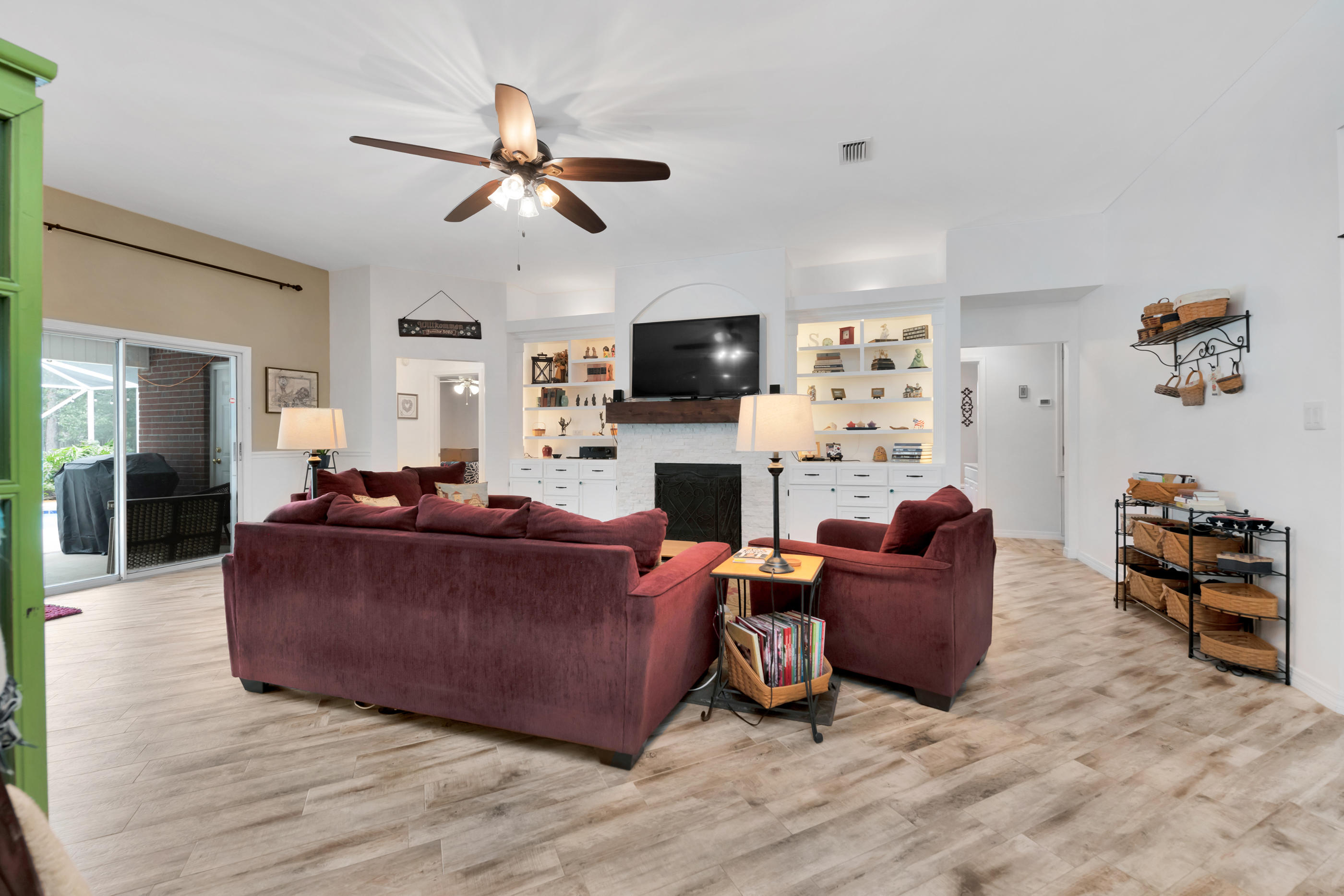 7159 Riverview Road Navarre, FL 32566 - Photo 9 of 36 a living room with fireplace furniture and a flat screen tv