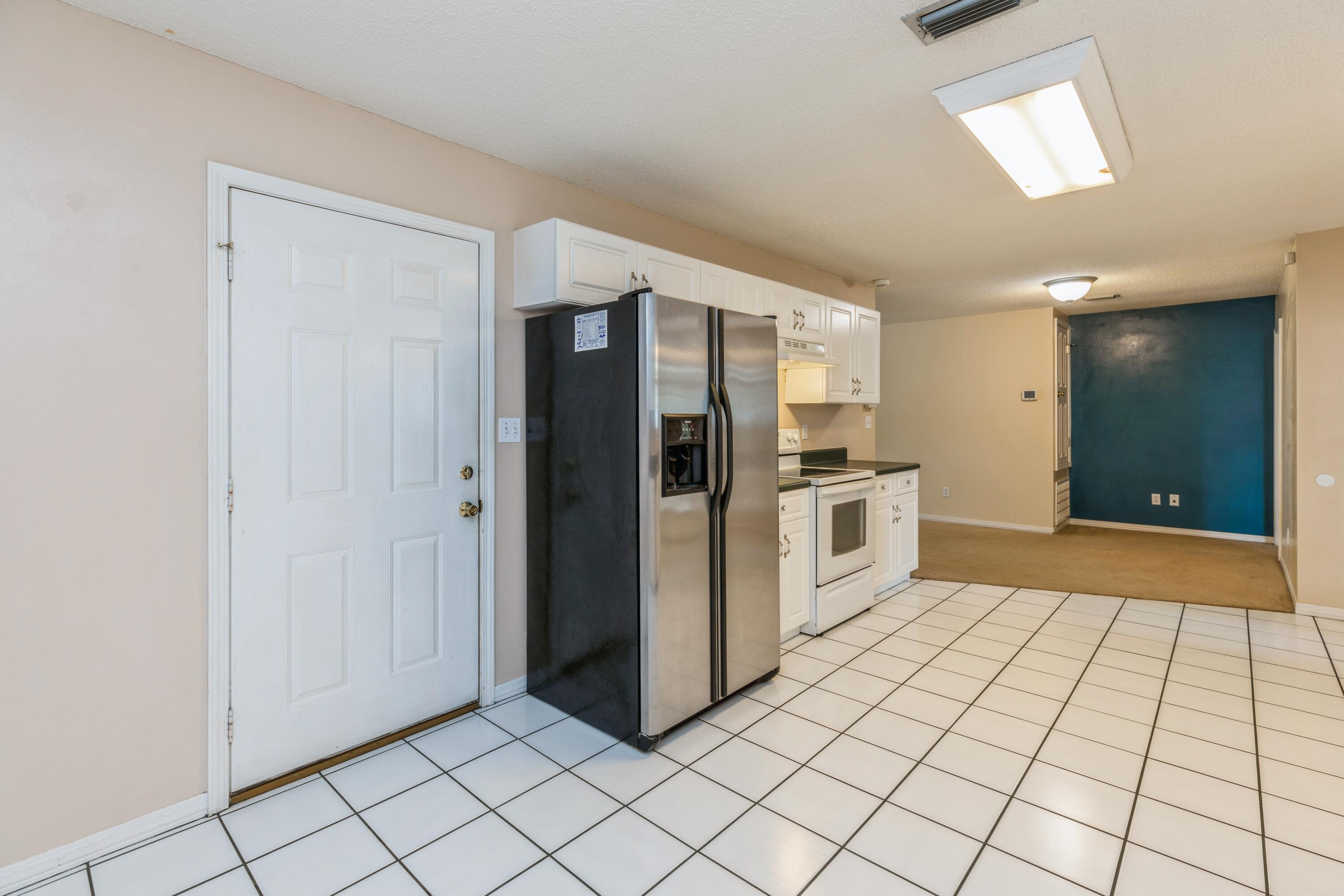 1759 Old Ranch Road Fort Walton Beach, FL 32547 - Photo 14 of 33 a kitchen with granite countertop a refrigerator and a stove top oven