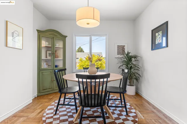a view of a dining room with furniture and a potted plant