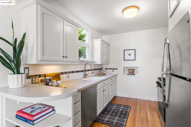 a kitchen with a refrigerator and a sink