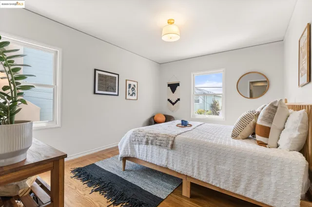 a bedroom with a bed and a potted plant