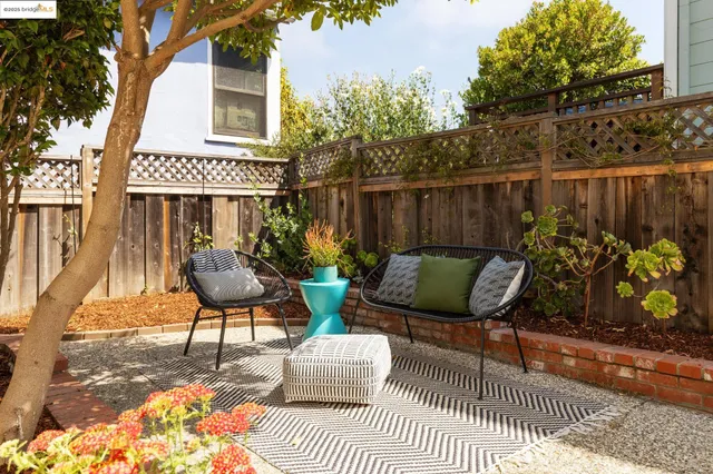 a view of a chairs and tables in the back yard of the house