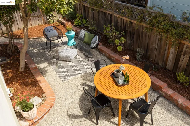 a view of a chairs and table in backyard