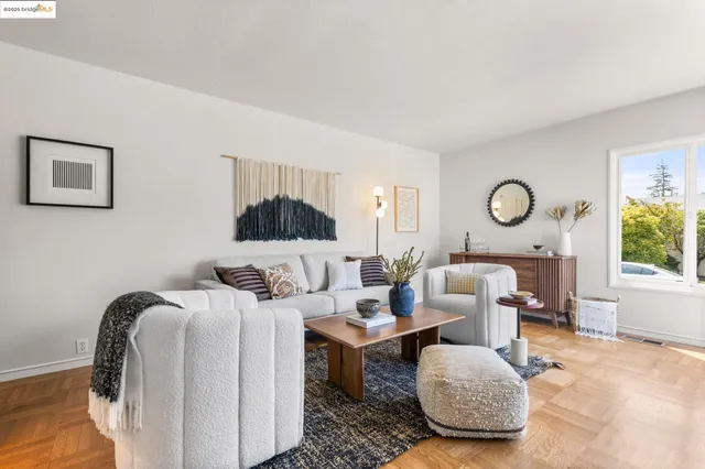a living room with furniture a rug and a window