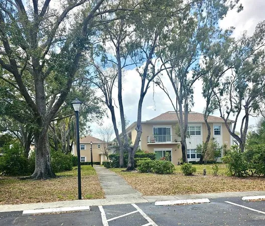 a front view of a house with a tree