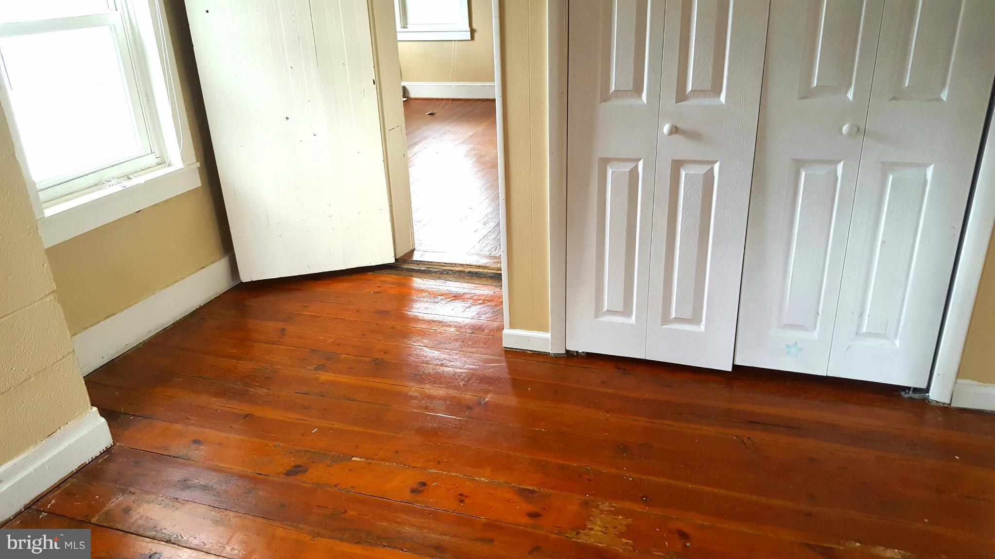 534 Punch Run Road Front Royal, VA 22630 - Photo 14 of 27 a view of an empty room with wooden floor and a window