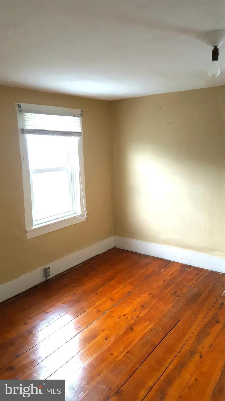 534 Punch Run Road Front Royal, VA 22630 - Photo 15 of 27 an empty room with wooden floor and windows