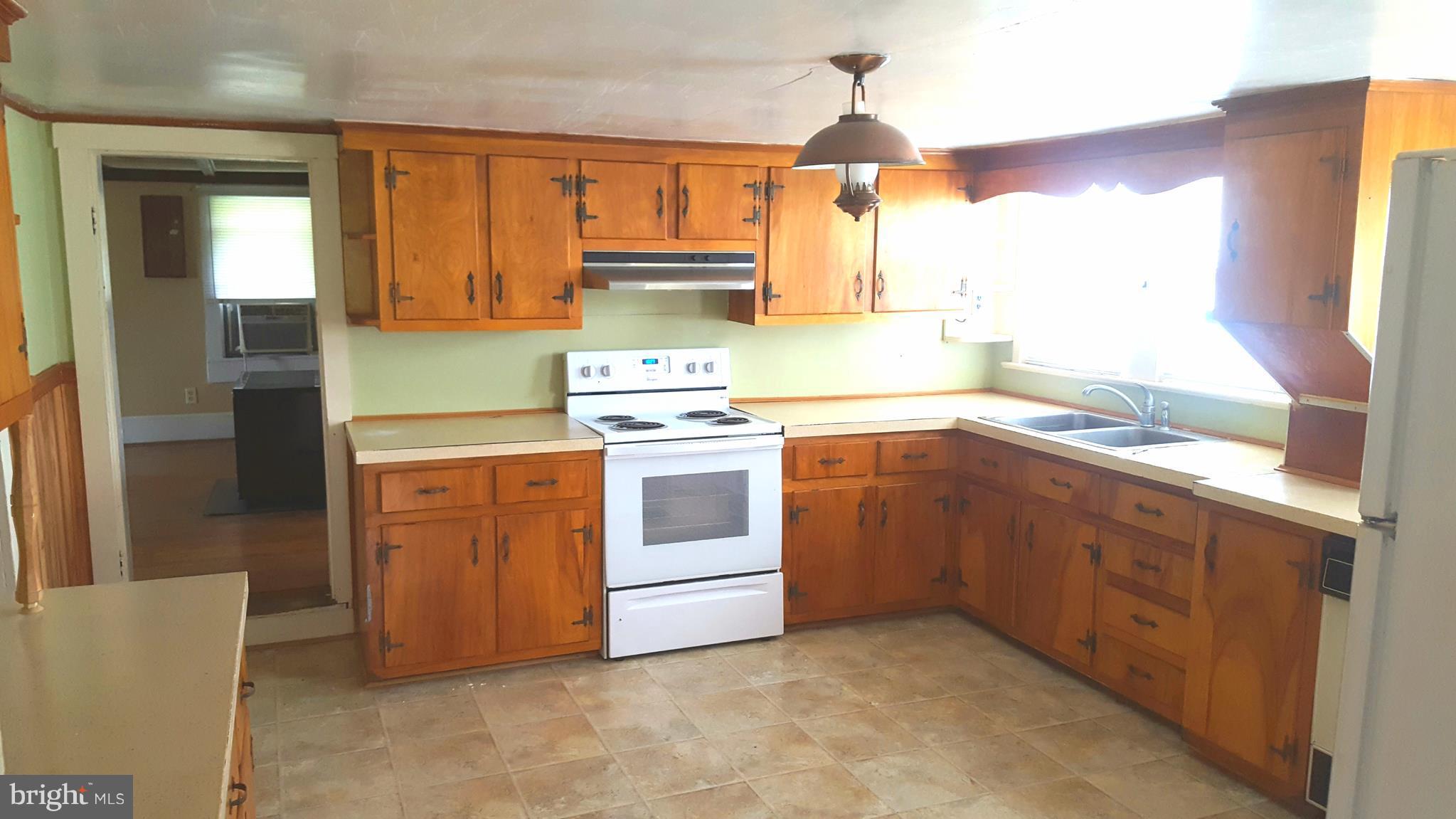 534 Punch Run Road Front Royal, VA 22630 - Photo 23 of 27 a kitchen with stainless steel appliances a stove a sink and a refrigerator