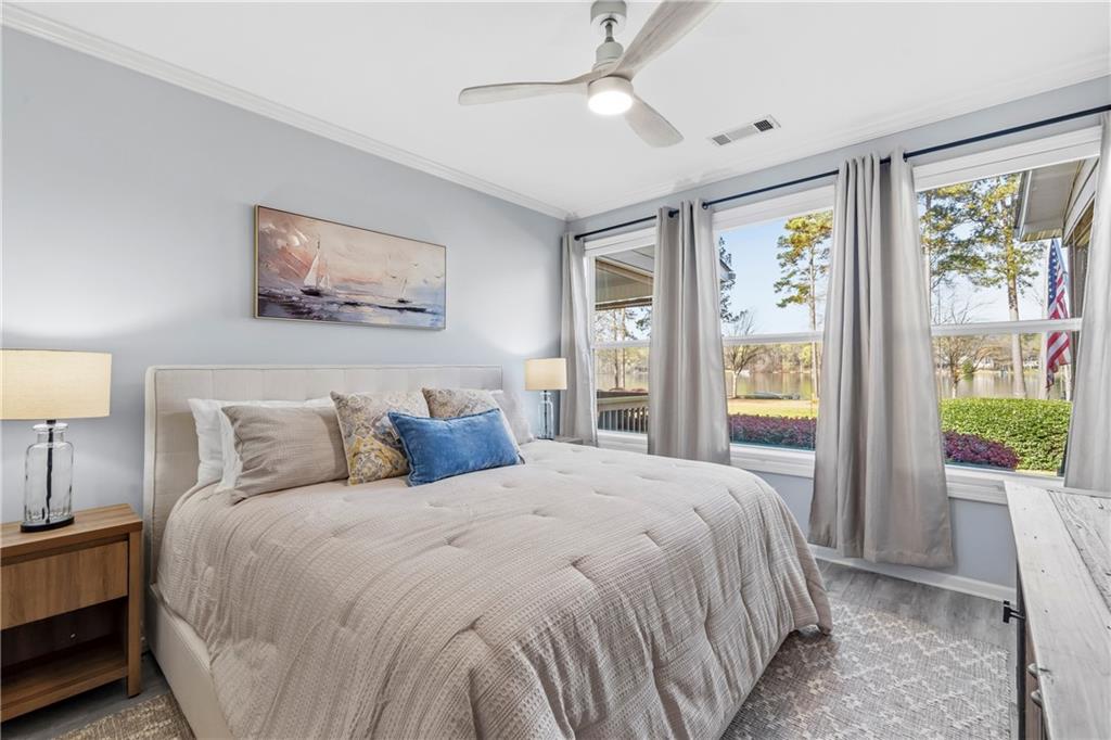549 Old Phoenix Road Northeast, Unit 104 Eatonton, GA 31024 - Photo 16 of 48 a bedroom with a large bed and a window