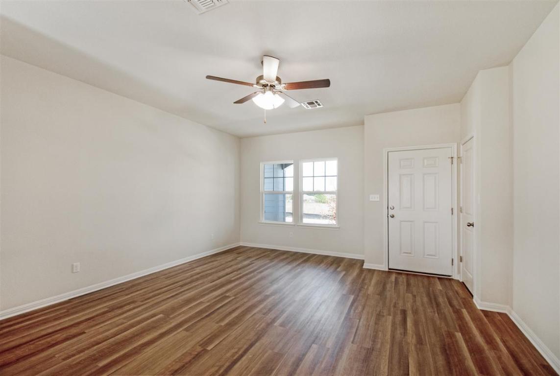 404 Spiny Lizard Lane San Marcos, TX 78666 - Photo 11 of 28 wooden floor in an empty room with a window