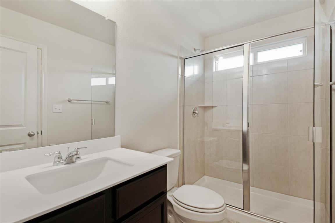 404 Spiny Lizard Lane San Marcos, TX 78666 - Photo 12 of 28 a bathroom with a sink a toilet and shower