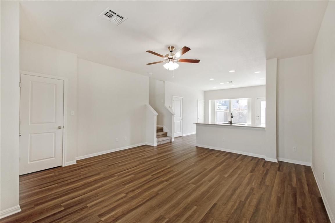 404 Spiny Lizard Lane San Marcos, TX 78666 - Photo 4 of 28 wooden floor in an empty room with a window