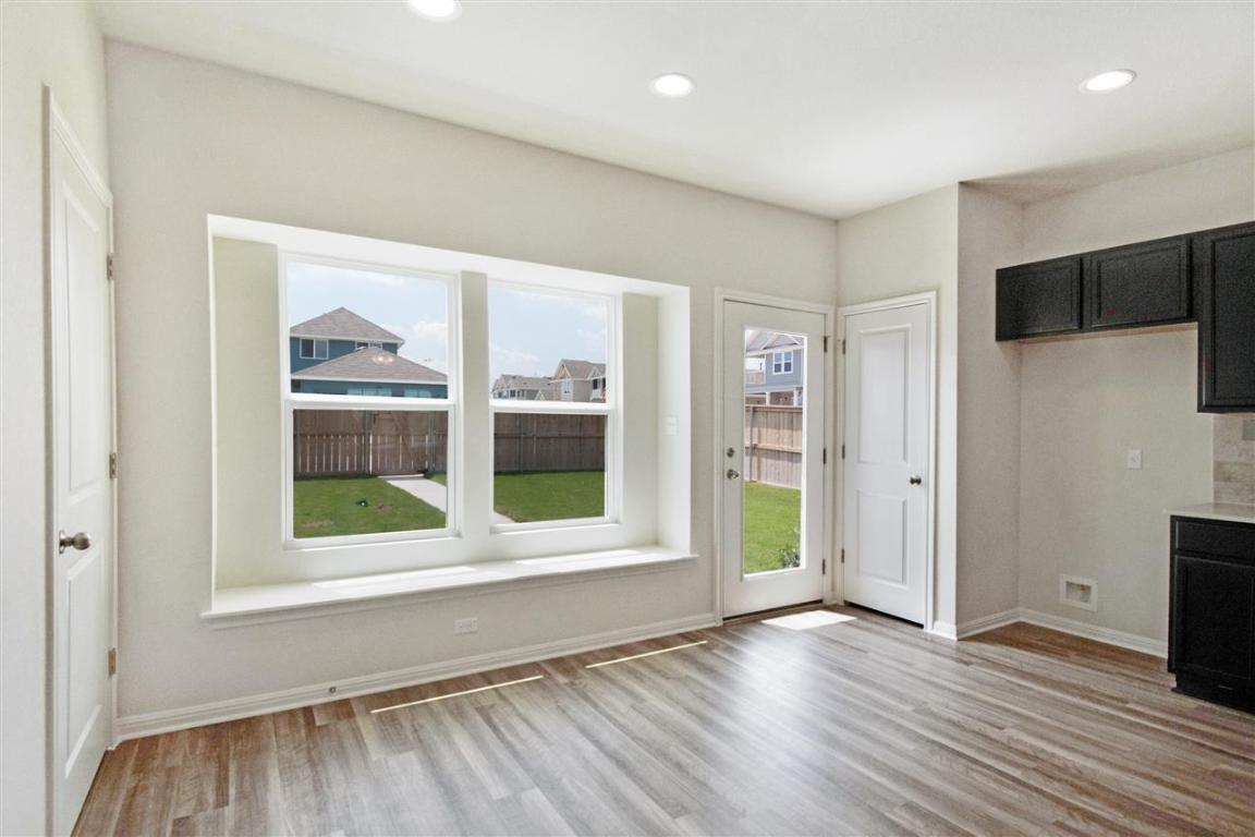 404 Spiny Lizard Lane San Marcos, TX 78666 - Photo 5 of 28 an empty room with wooden floor and windows