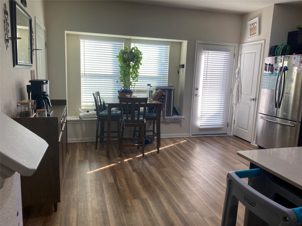 404 Spiny Lizard Lane San Marcos, TX 78666 - Photo 6 of 28 a view of a dining room with furniture window and wooden floor