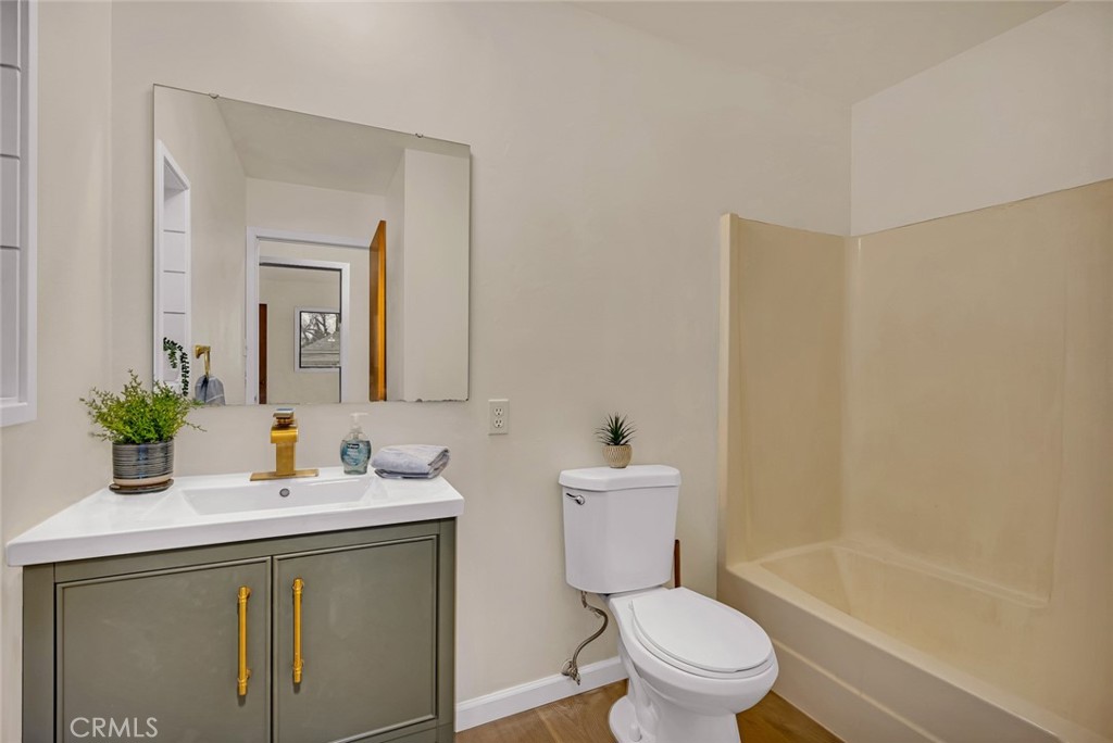 358 Sycamore Avenue Gustine, CA 95322 - Photo 11 of 37 a bathroom with a sink a toilet and a mirror