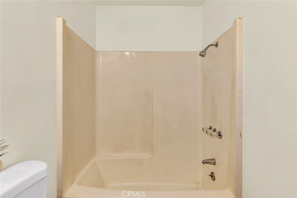 358 Sycamore Avenue Gustine, CA 95322 - Photo 12 of 37 a bathroom with a shower and a bath tub